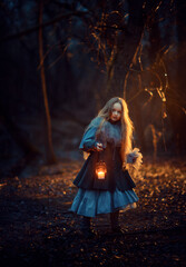 Girl with candle in the night forest