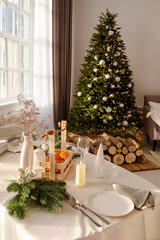 Beautiful table setting with Christmas decorations in living room. Dinner or lunch