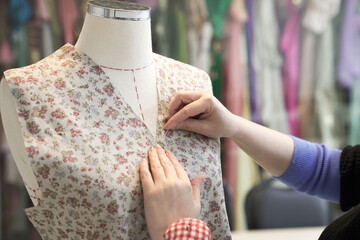 Tailor woman sewing beautiful dress