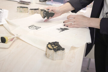 Woman printing car motif on tote bag