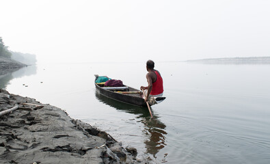 A boatman sailing through the waters of the river Brahmaputra in Guwahati, Assam, India