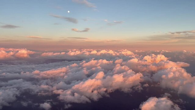 Front view from the cabin of a commercial plane in flight at sunset flying over the clouds