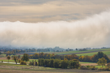 huge wall of white fog over a village in the nature landscape detail