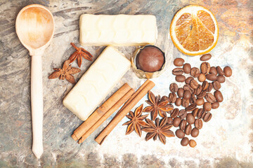 White chocolate candies with anise,cinnamon sticks,coffee beans. Top view