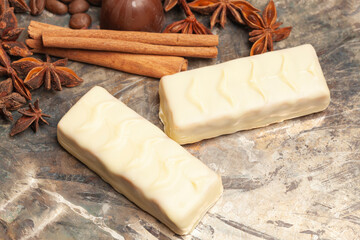 White chocolate candies with anise,cinnamon sticks,coffee beans.