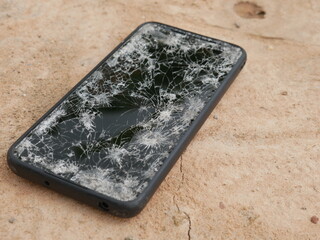 The smartphone hit the floor, it fell into a crack.