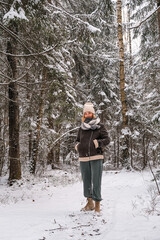 Winter.woman walks through winter snowy forest. Mental and physical health. Unity with nature.travel outdoors, hiking, spending time outdoors,winter travel,slow life,christmas forest.