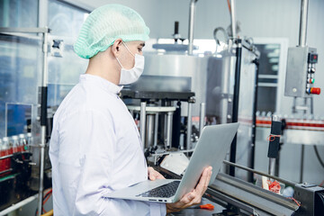 food and drink industry staff worker working at conveyor belt production line machine in beverage...