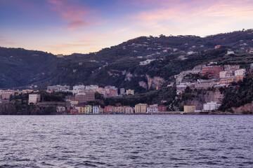 Fototapeta premium Homes and Hotels in a touristic town on the seafront. Sorrento, Compania, Italy. Colorful Sunrise Sky Art Render.