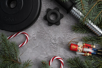 Dumbbell barbell weight plate, Christmas nutcracker, decorative candy canes and tree branches....
