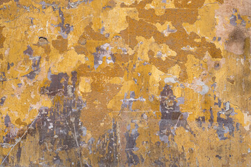 old wall with worn, faded and peeling paint.