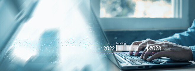 Countdown to 2023 concept. the taps a virtual download bar with a loading progress meter on New Year's Eve, turning the year 2022 to 2023. - obrazy, fototapety, plakaty