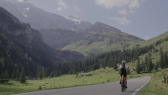 Mountain bike rider in front of beautiful alpine panorama in Switzerland. Sport in nature is very relaxing and good for health. Healthy lifestyle due to training in high altitude.