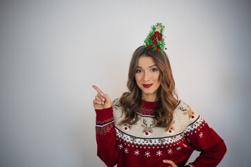 Happy person wearing christmas sweater pointing