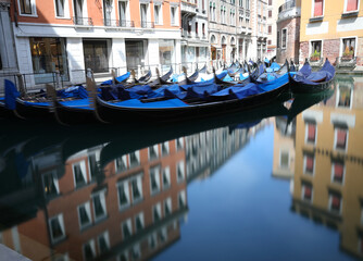 Fototapeta na wymiar GONDOLE boats in Venice without people due to the lockdown in Italy and the reflection on the water