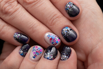 New Year's manicure on short nails, dark blue gel polish, decorated with sequins and a Christmas tree, close-up
