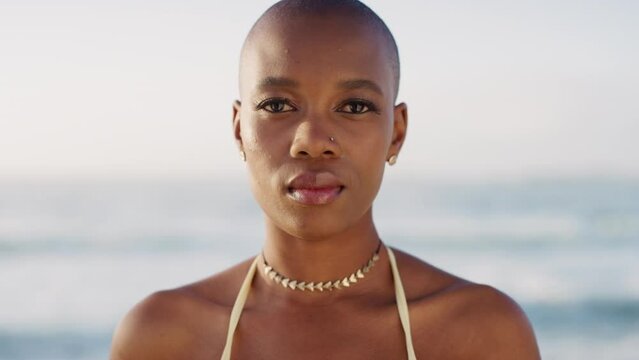 Calm, ocean and black woman face from Madagascar in nature feeling relax. Bald, beautiful and young person staring and ready for sea, beach and waves swim on a summer holiday travel with peace