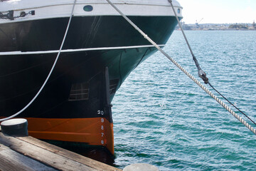 Stern and rudder of historic tall ship museum docked in the harbor