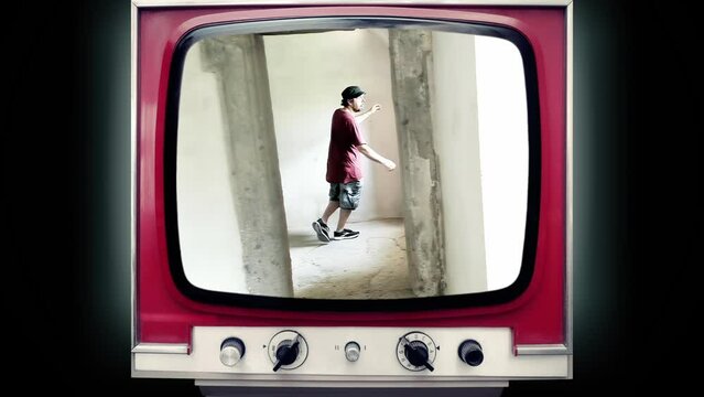A transmission on an old retro tv set: a disoriented man moving in slow motion into an oblique room, exploring its weirdness. Funny bizarre shot.

