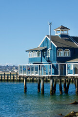 vintage waterfront building built on pylons in the harbor