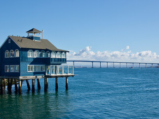 vintage waterfront building built on pylons in the harbor