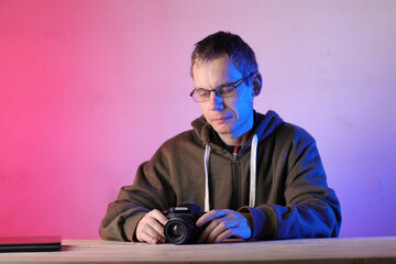 digital slr camera with an old lens in the hands of a person