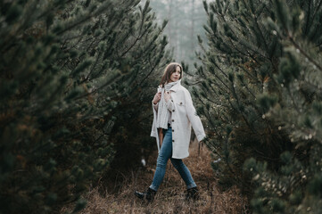 Naklejka na ściany i meble Woman enjoy the pine wood forest - fashion photography