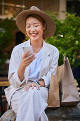 Shopping, city and woman in Japan with smartphone for ecommerce website, fintech and internet deal...
