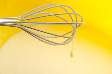 The cook beats the flour with a whisk into the dough for pancakes	
