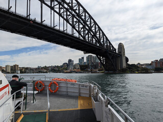 A view from a ferry about to go under the famous harbour bridge,  in Sydney, NSW, Australia.