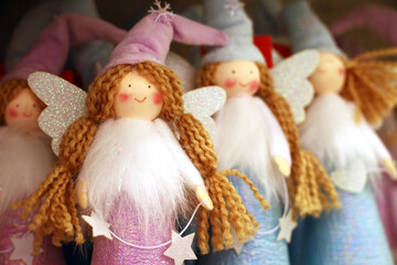Christmas angels in a souvenir shop. New Year toys, doll fairies