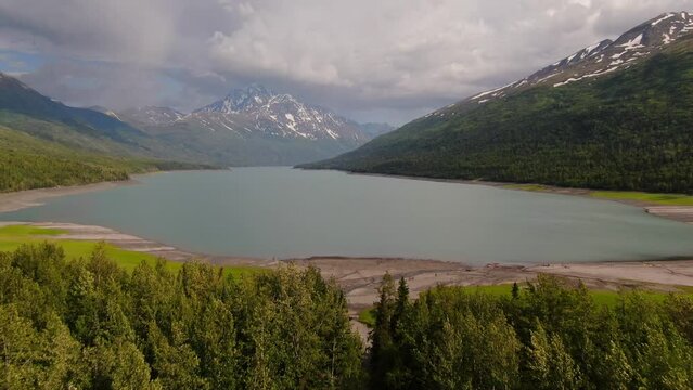 Alaska Lakeside Landscape On Cloudy Summer Day, Beautiful Panoramic Aerial View of Wild Nature, Valley Lake With Green Forest and Mountains Around