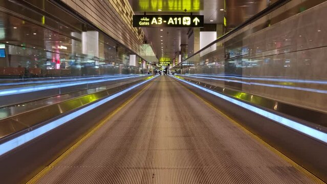 Escalator moving closer to an airport gate A3-A11 in Qatar airport Doha