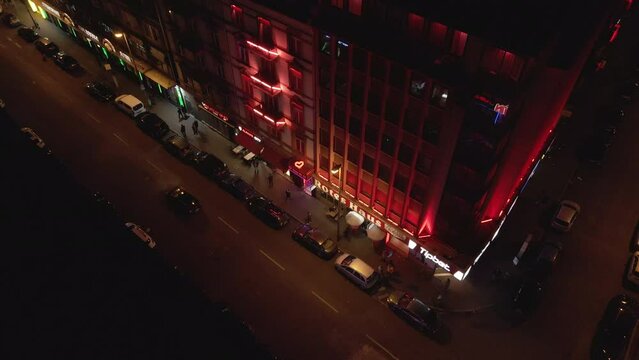 Drone is filming in Frankfurt, on Taunusstrasse, the focus is on a hotel in the red-light district of Frankfurt, the camera is filming down the street with many cars and people