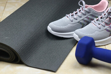 Grey Sport shoes on sport mattress. Indoor workout concept and healthy lifestyle. Sport equipment background.