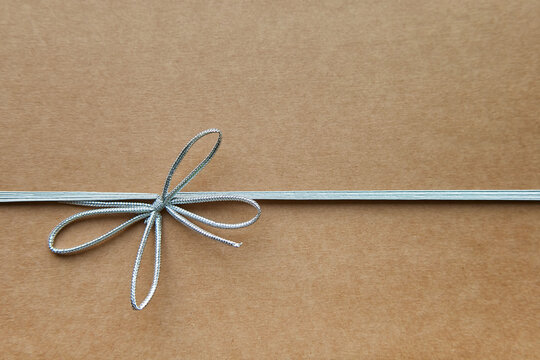 brown cardboard box with silver ribbon