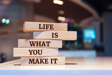 Wooden blocks with words 'Life is what you make it'. - obrazy, fototapety, plakaty