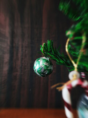 Decorated Green ball hanging on Christmas tree