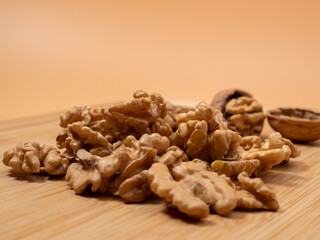 Walnut on an orange background. Raw walnut.