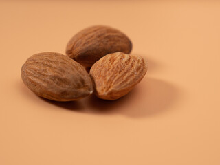 Almond nut on an orange background. Raw almond.