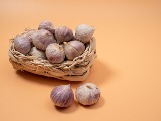 Heads of garlic on an orange background.