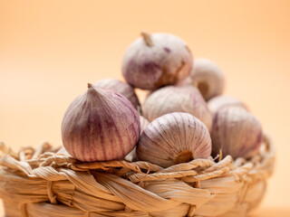 Heads of garlic on an orange background.