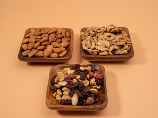 Various nuts on an orange background. Mixed nuts.