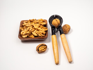 Walnut and nutcracker on a white background. Raw walnut.