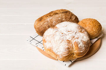 Homemade natural breads. Different kinds of fresh bread as background, perspective view with copy space