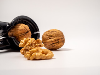 Walnut and nutcracker on a white background. Raw walnut.