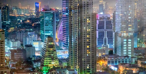 City skyline aerial view at night in Bangkok, Thailand.