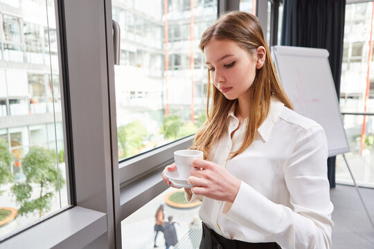 Young business woman drinking coffee on a break