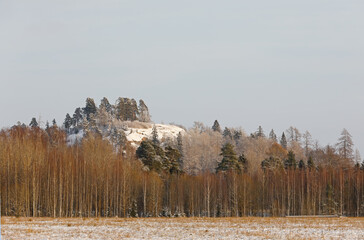 A small sowy hill against light blue sky in winter © puteli