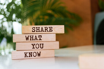 Wooden blocks with words 'Share What You Know'.